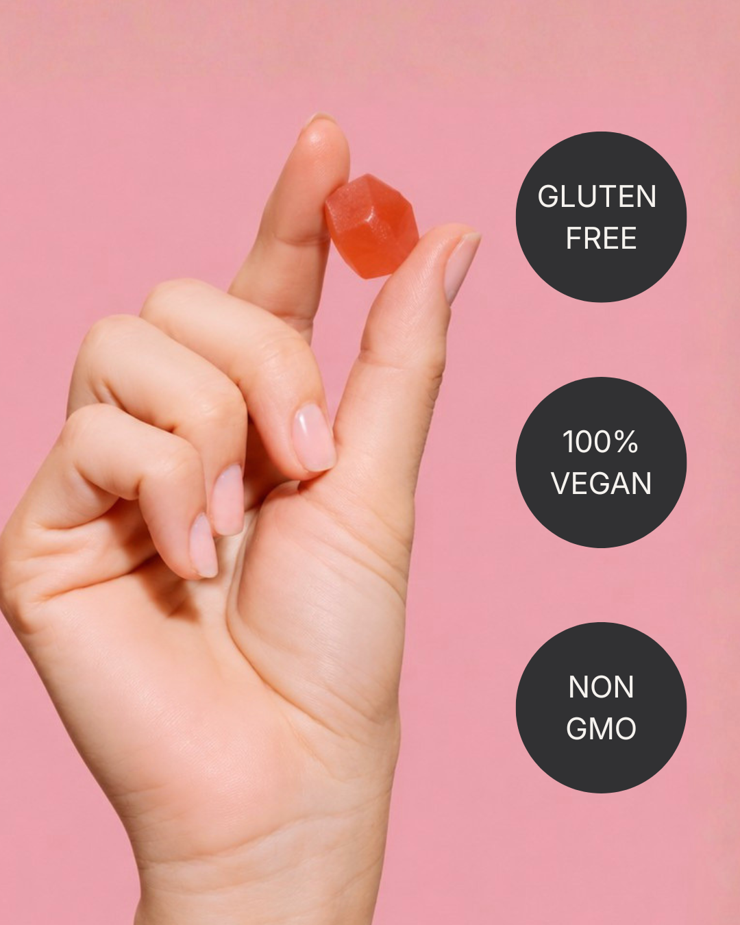 A hand holding a gummy beside badges reading gluten free, 100% vegan and non GMO